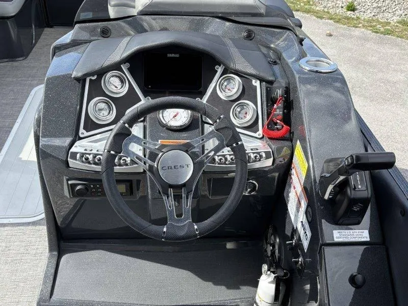 Slide: The Image of 2023 Crest Caribbean RS 230 SLC boat dashboard with steering wheel and control panel. - 45