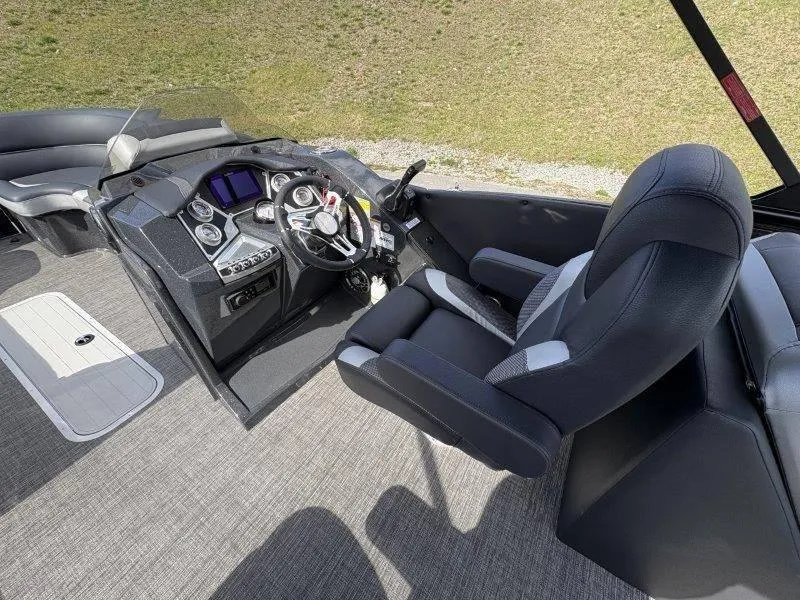 Slide: The Image of 2023 Crest Caribbean RS 230 SLC boat interior with steering console and seating. - 46