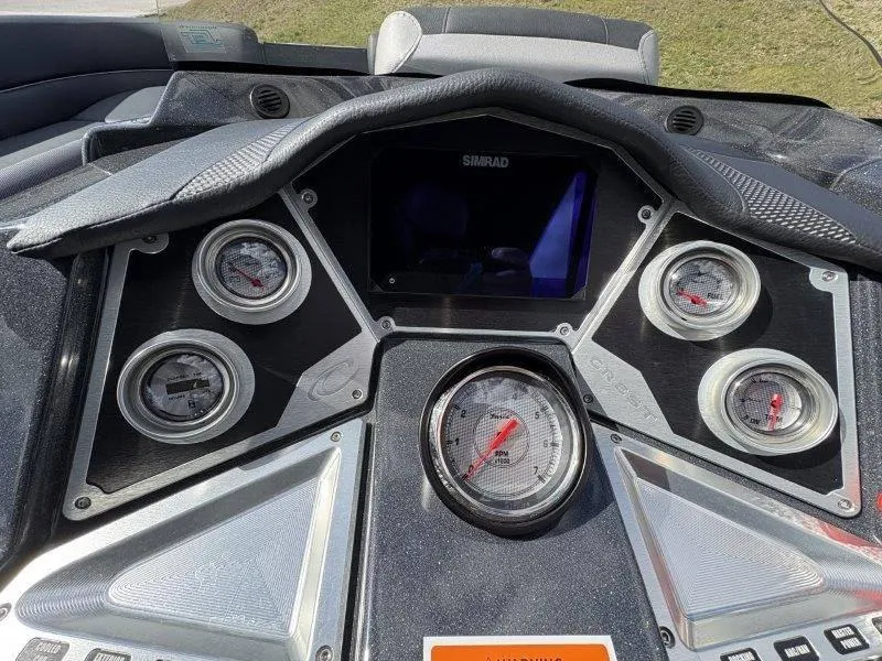 Slide: The Image of Dashboard of 2023 Crest Caribbean RS 230 SLC with gauges and Simrad display. - 49