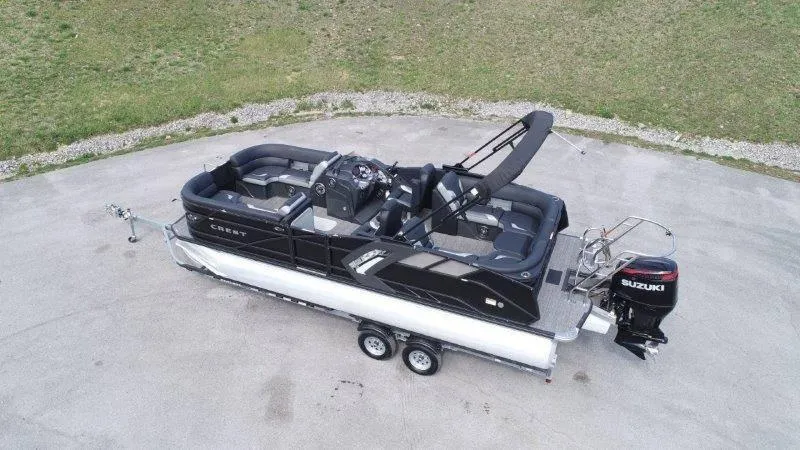 Slide: The Image of 2023 Crest Caribbean RS 230 SLC pontoon boat with Suzuki outboard engine on trailer. - 5