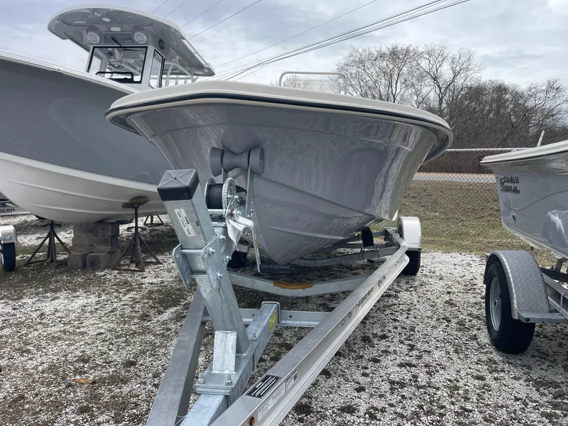 Slide: The Image of 2025 Carolina Skiff EV218 Sea Skiff on trailer, parked outdoors. - 2