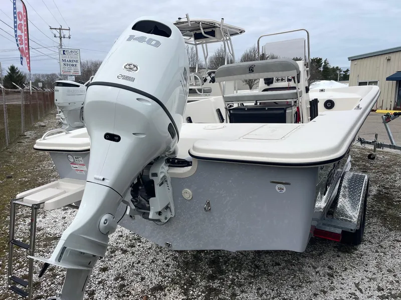 Slide: The Image of 2025 Carolina Skiff EV218 Sea Skiff with outboard motor on trailer. - 6