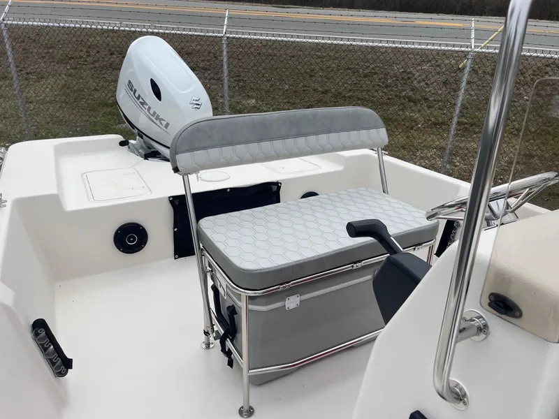 Slide: The Image of 2025 Carolina Skiff EV218 Sea Skiff interior with seating and Suzuki outboard motor. - 8
