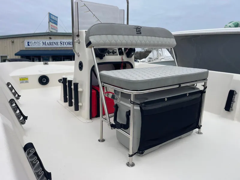 Slide: The Image of 2025 Carolina Skiff EV218 Sea Skiff interior with seating and console, near marine store. - 9