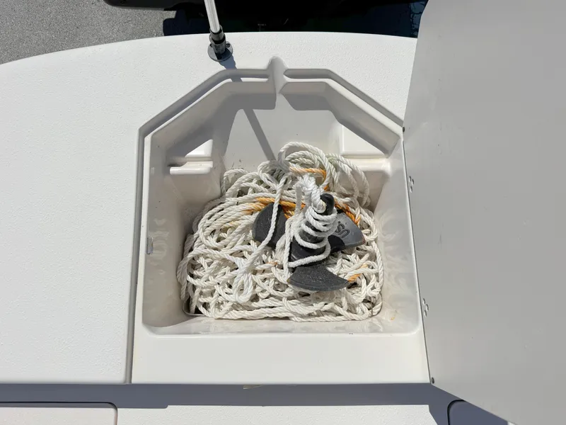 Slide: The Image of Anchor storage compartment on a 2020 Carolina Skiff 19 LS boat, featuring coiled rope. - 10