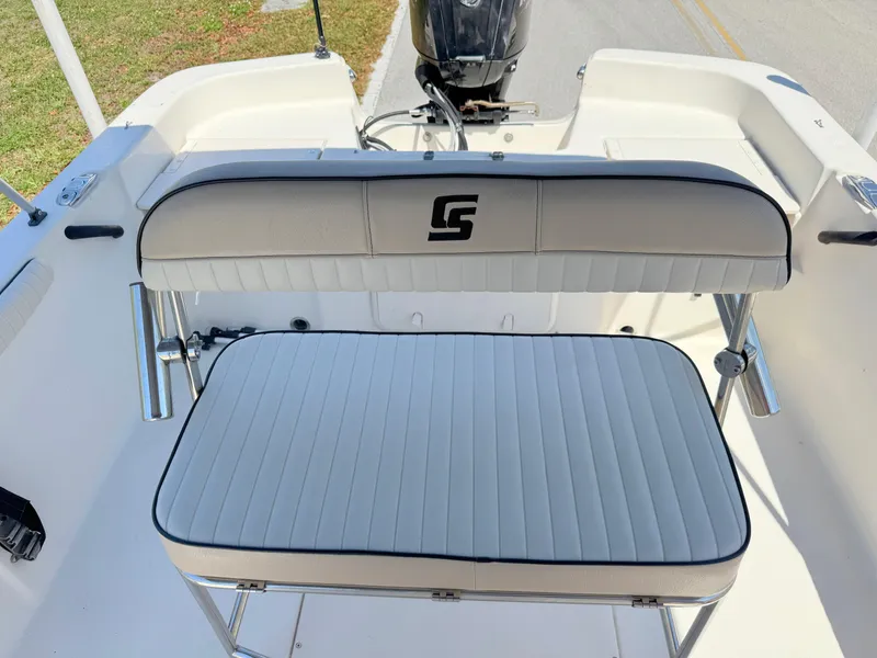 Slide: The Image of 2020 Carolina Skiff 19 LS boat seating with logo, white cushioned bench. - 13