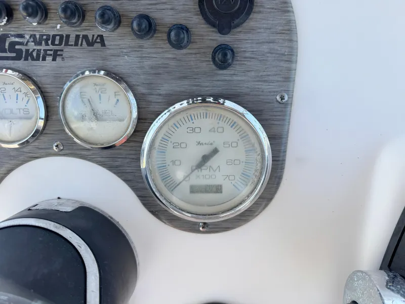Slide: The Image of Dashboard of a 2020 Carolina Skiff 19 LS boat with gauges and controls. - 16