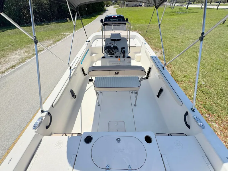 Slide: The Image of 2020 Carolina Skiff 19 LS boat interior with canopy, steering console, and seating. - 22