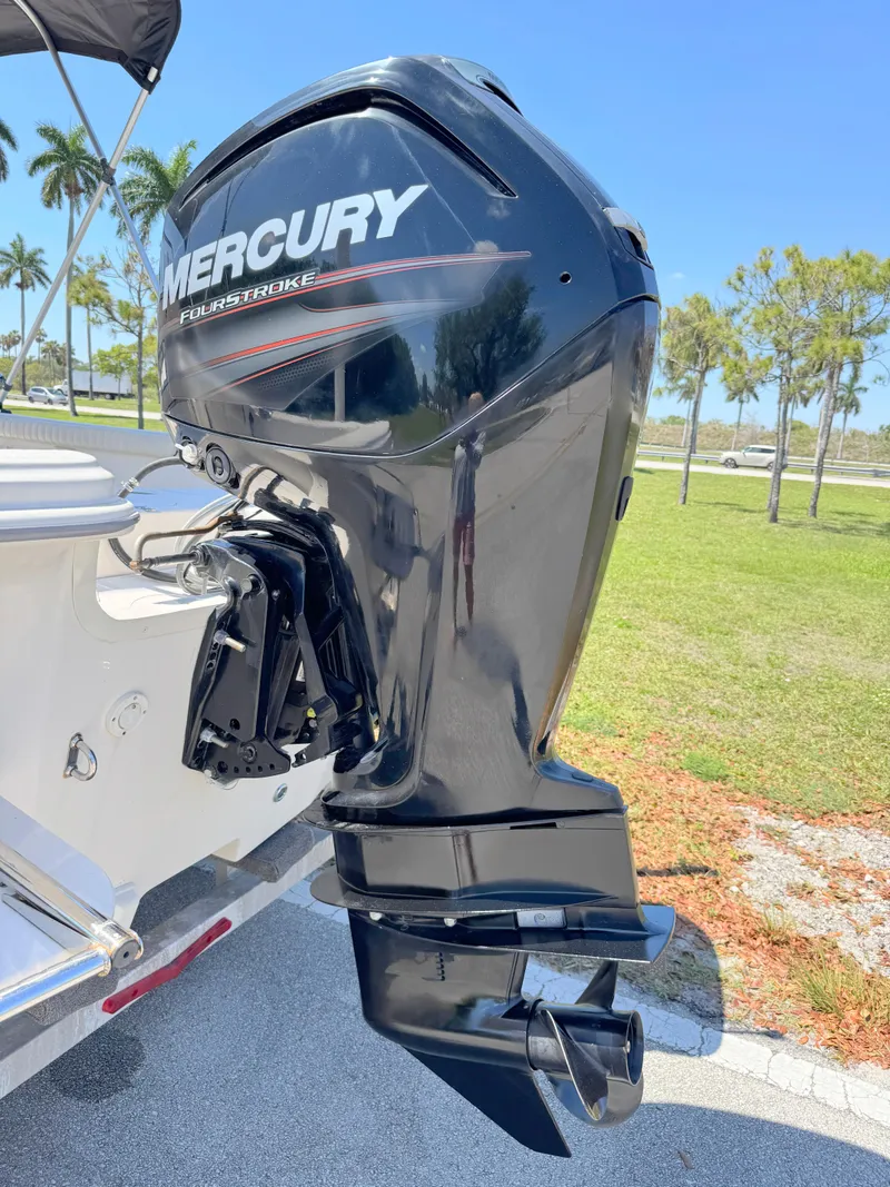Slide: The Image of 2020 Carolina Skiff 19 LS with Mercury outboard motor, parked outdoors. - 25