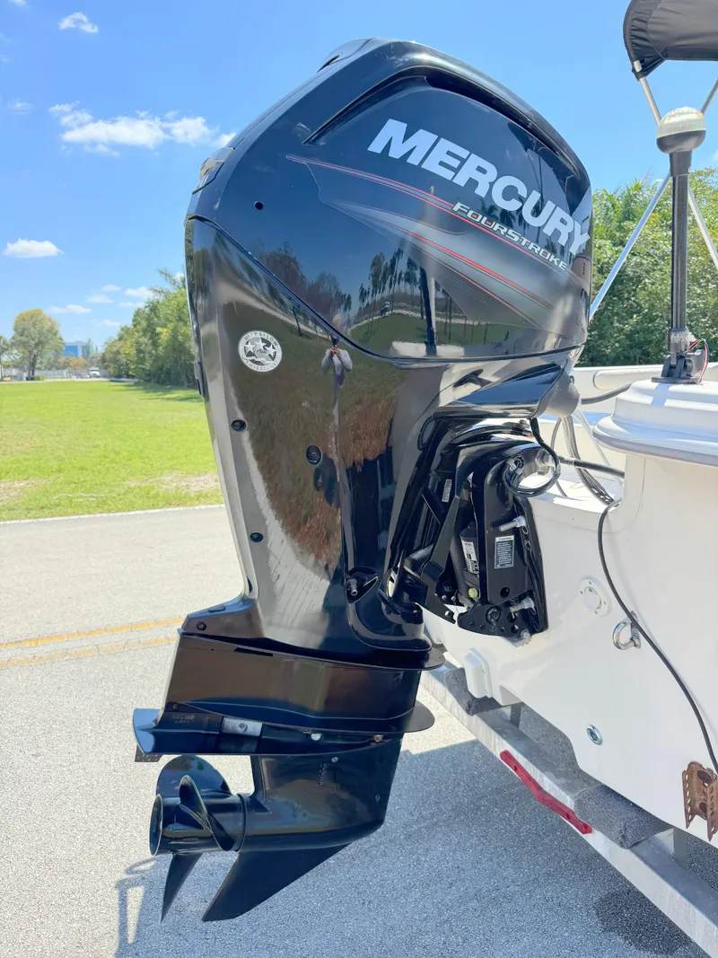 Slide: The Image of 2020 Carolina Skiff 19 LS with Mercury outboard engine, parked outdoors on a sunny day. - 26