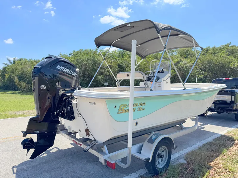 Slide: The Image of 2020 Carolina Skiff 19 LS boat on trailer with Mercury outboard motor, parked outdoors. - 4