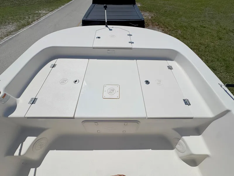 Slide: The Image of 2020 Carolina Skiff 19 LS boat deck with storage compartments, parked on a trailer. - 7