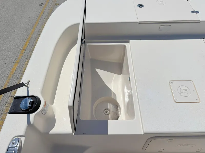 Slide: The Image of 2020 Carolina Skiff 19 LS boat deck with storage compartment and clean white finish. - 8