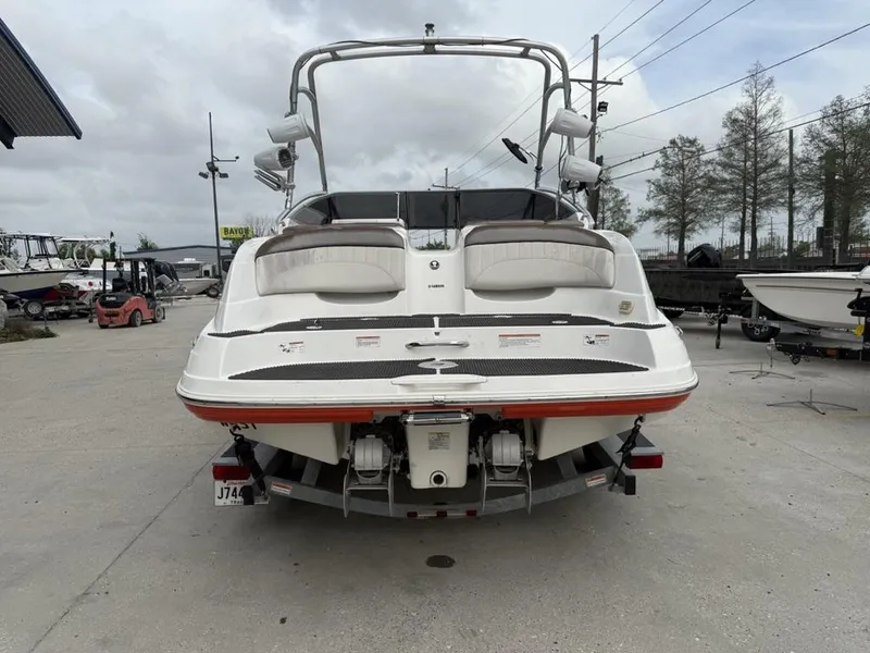 Slide: The Image of 2007 Yamaha Boats AR 230, rear view, parked on a trailer in a marina. - 5