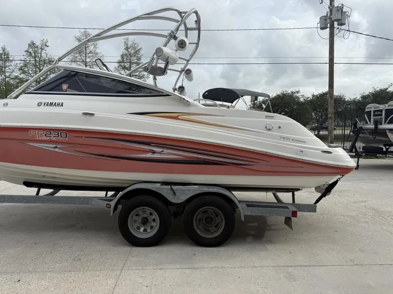 Slide: The Image of 2007 Yamaha AR 230 boat on trailer, side view, with twin engines. - 7