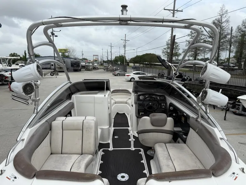 Slide: The Image of 2007 Yamaha Boats AR 230 interior with seating and dashboard, parked outdoors. - 9