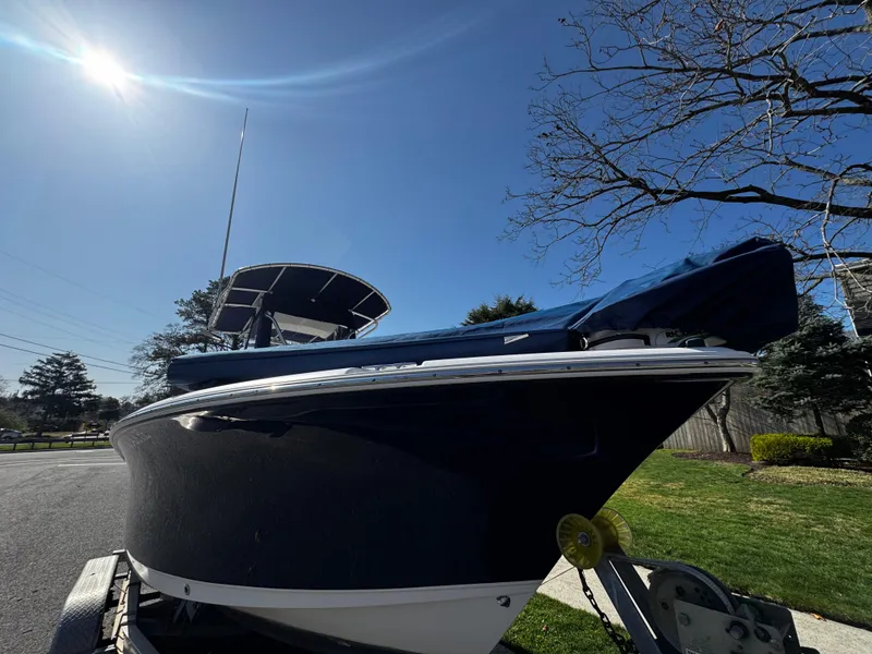 Slide: The Image of 2012 Sea Hunt Triton 210 boat on trailer under clear blue sky. - 10
