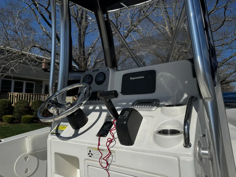 Slide: The Image of 2012 Sea Hunt Triton 210 boat console with steering wheel and Raymarine equipment. - 9