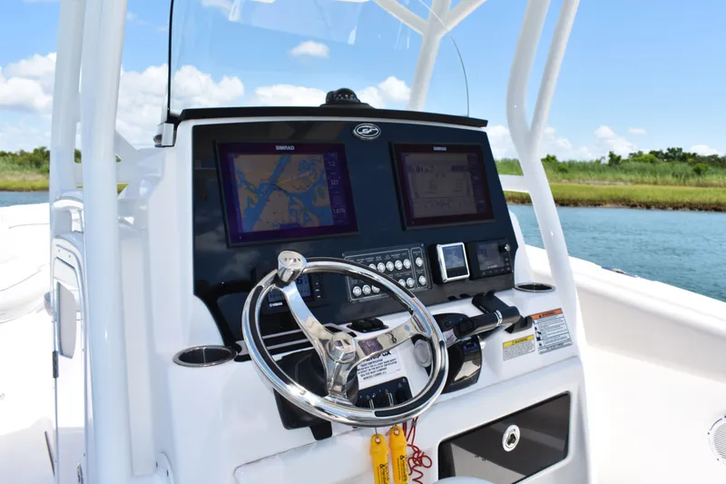 Slide: The Image of 2020 Sea Fox 288 Commander boat dashboard with navigation screens and steering wheel. - 18