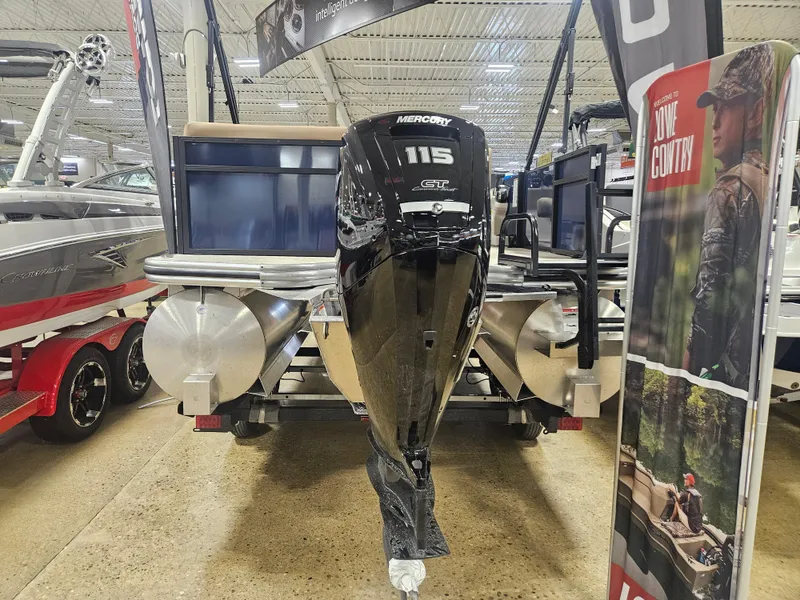 Slide: The Image of 2025 Lowe LS210 pontoon boat with Mercury 115 outboard motor displayed indoors. - 8