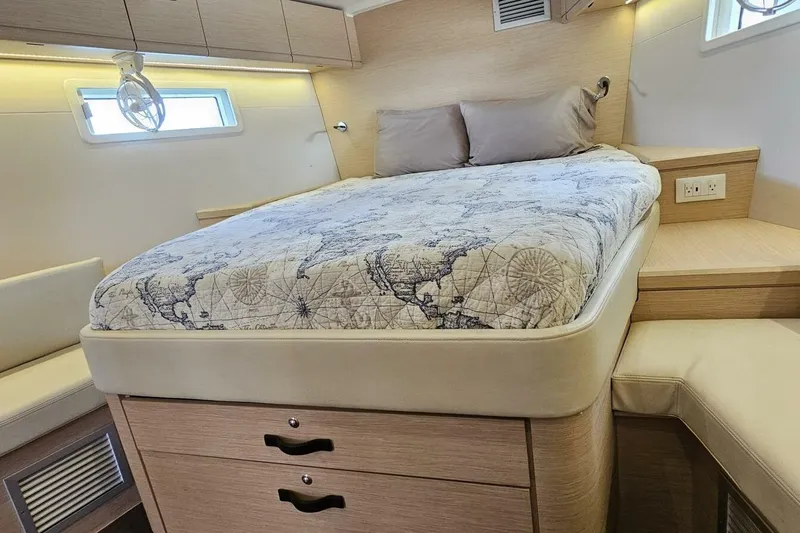 Slide: The Image of Luxurious cabin interior of 2017 Jeanneau Sun Odyssey 51 yacht with map-themed bedding. - 12