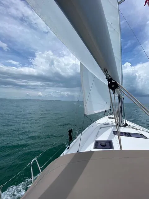 Slide: The Image of Sailing Jeanneau Sun Odyssey 51, 2017 model, on open sea under cloudy skies. - 21