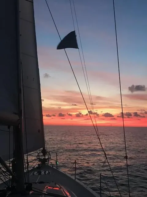 Slide: The Image of Jeanneau Sun Odyssey 51 sailing at sunset, 2017 model, with vibrant sky and ocean view. - 25