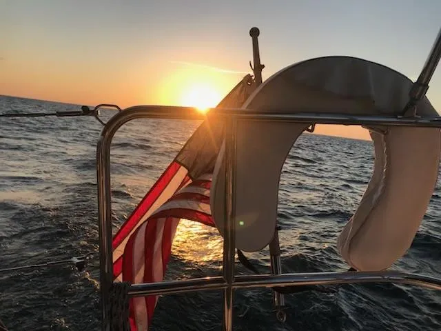 Slide: The Image of Jeanneau Sun Odyssey 51 sailing at sunset with American flag, 2017 model. - 26