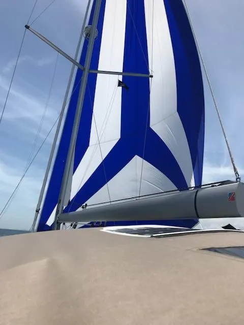 Slide: The Image of Jeanneau Sun Odyssey 51 sailboat with blue and white sails, 2017 model. - 34