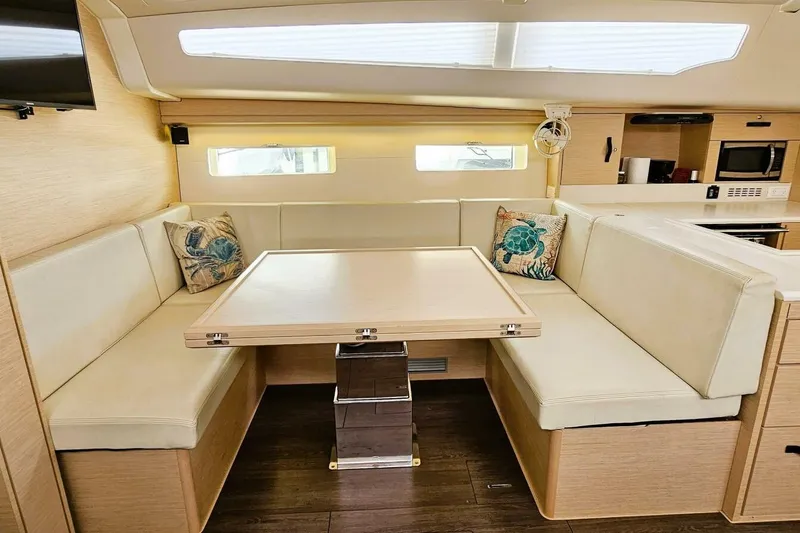 Slide: The Image of Luxurious interior of 2017 Jeanneau Sun Odyssey 51 yacht with cozy seating and table. - 4
