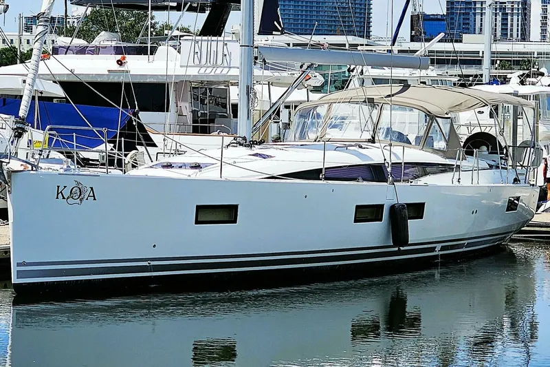 Slide: The Image of 2017 Jeanneau Sun Odyssey 51 yacht docked at marina, sleek design, white hull. - 48
