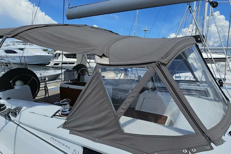 Slide: The Image of Jeanneau Sun Odyssey 51 sailboat, 2017 model, with protective canopy in marina setting. - 49