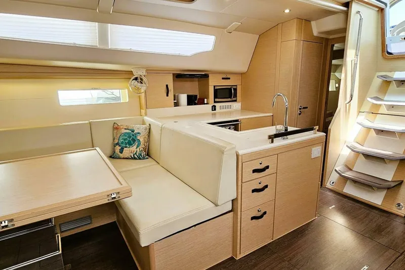 Slide: The Image of Luxurious interior of 2017 Jeanneau Sun Odyssey 51 yacht with modern kitchen and seating area. - 5