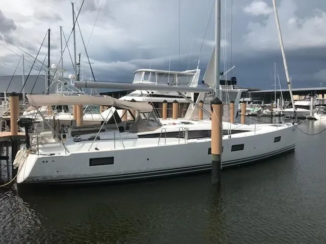 The Image of Jeanneau Sun Odyssey 51 sailboat docked at marina, 2017 model, under cloudy skies. - 0