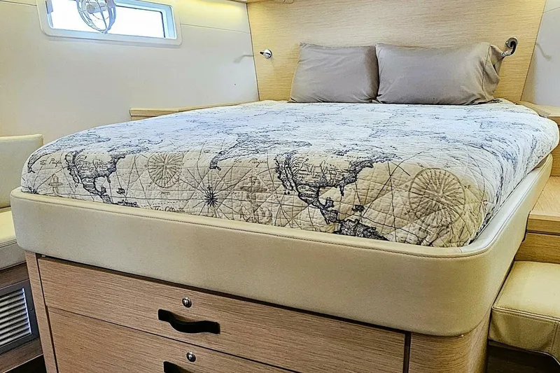 Slide: The Image of Luxurious cabin interior of 2017 Jeanneau Sun Odyssey 51 with map-themed bedding. - 11