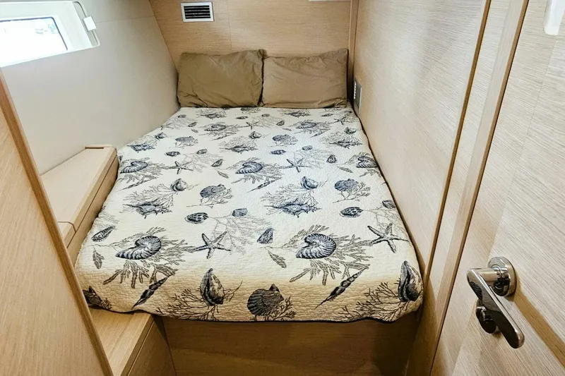 Slide: The Image of Cozy cabin bedroom in 2017 Jeanneau Sun Odyssey 51 yacht with nautical-themed bedding. - 16