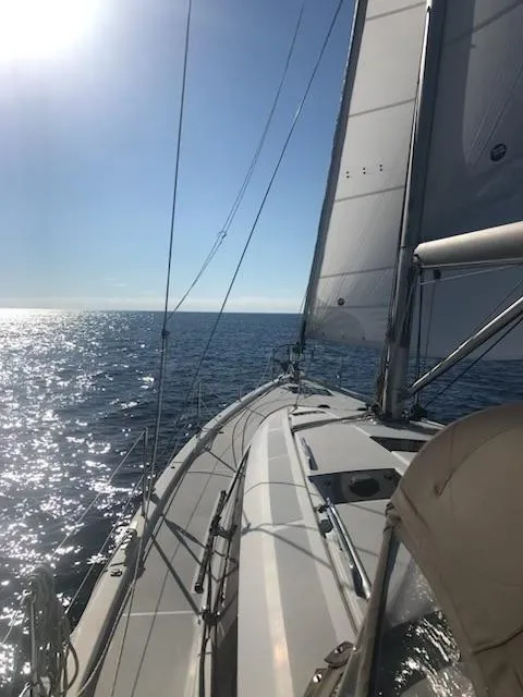 Slide: The Image of 2017 Jeanneau Sun Odyssey 51 sailing on open sea under clear blue sky. - 22