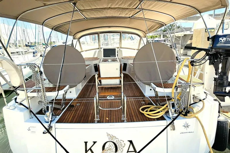 Slide: The Image of Jeanneau Sun Odyssey 51 sailboat, 2017 model, docked with covered seating and equipment. - 40