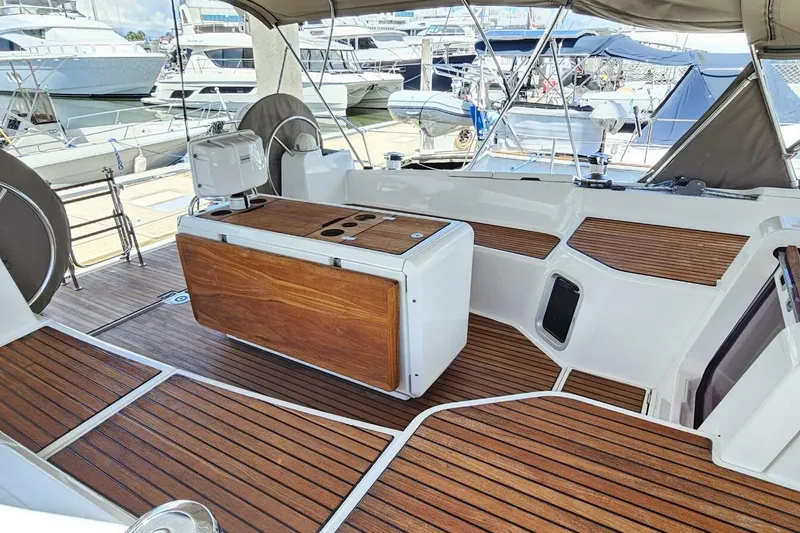 Slide: The Image of 2017 Jeanneau Sun Odyssey 51 yacht cockpit with wooden flooring and seating at marina. - 43
