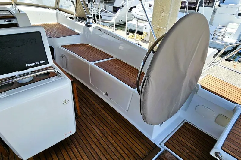 Slide: The Image of Cockpit of 2017 Jeanneau Sun Odyssey 51 with teak flooring and Raymarine equipment. - 46