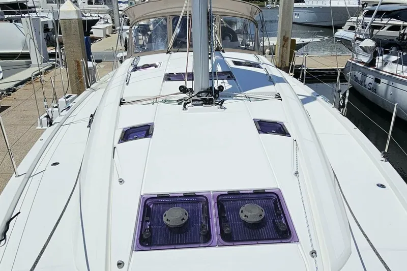 Slide: The Image of Jeanneau Sun Odyssey 51 sailboat, 2017 model, docked at marina, showcasing deck and hatches. - 52
