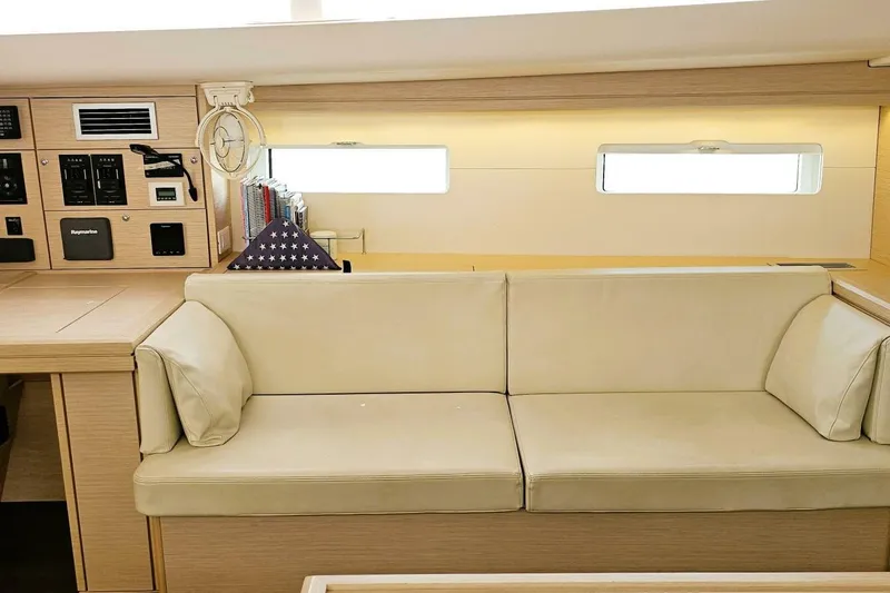 Slide: The Image of Interior of 2017 Jeanneau Sun Odyssey 51 yacht with beige seating and control panel. - 6