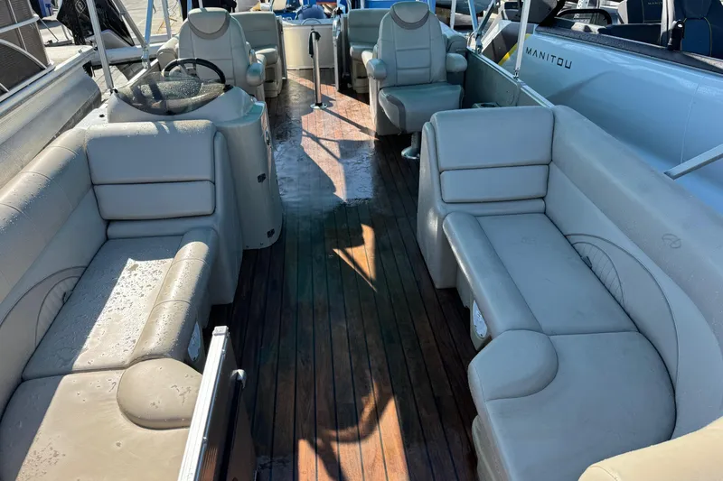 Slide: The Image of 2016 Avalon 2585 QL pontoon boat interior with beige seating and wooden deck. - 1