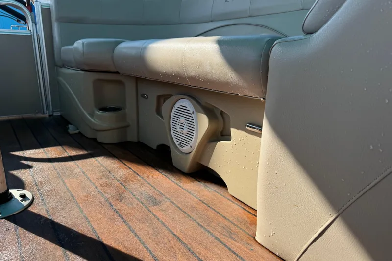 Slide: The Image of 2016 Avalon 2585 QL boat interior with beige seating and wooden flooring. - 12