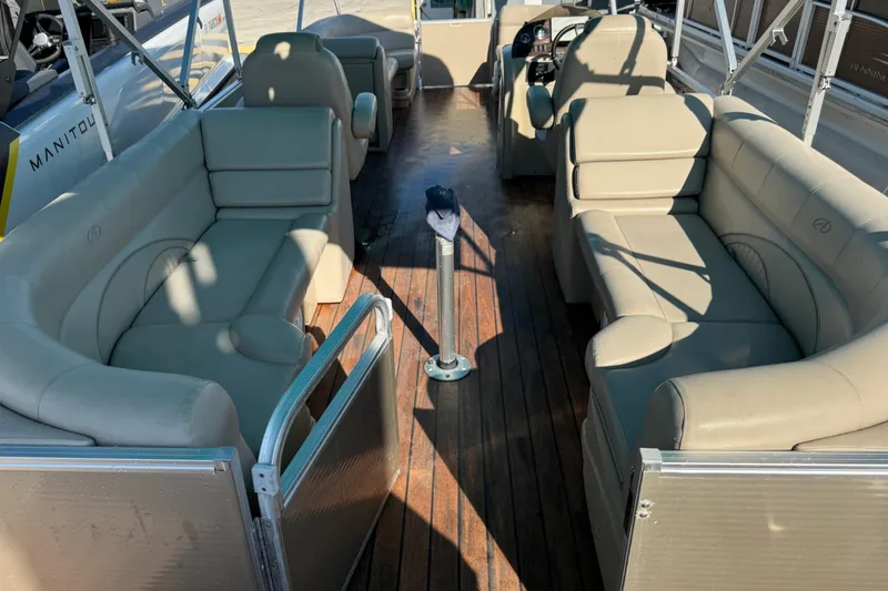 Slide: The Image of 2016 Avalon 2585 QL pontoon boat interior with beige seating and wooden deck. - 13