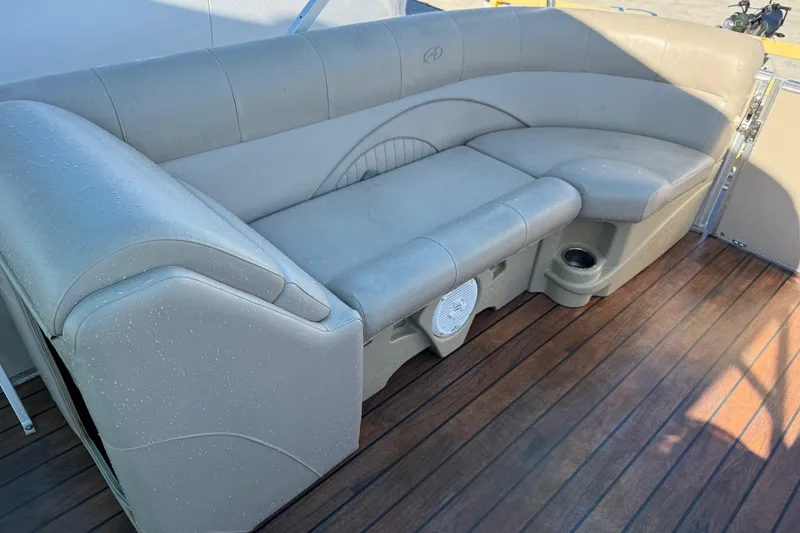 Slide: The Image of Luxurious seating on 2016 Avalon 2585 QL boat with wood flooring and built-in speaker. - 15