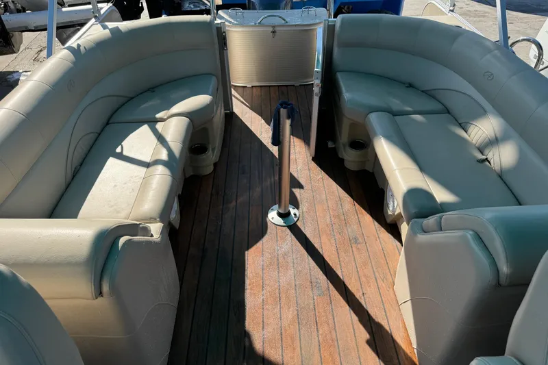 Slide: The Image of 2016 Avalon 2585 QL boat interior with beige seating and wooden flooring. - 5