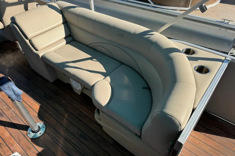 Slide: The Image of Luxurious seating on 2016 Avalon 2585 QL boat with cup holders and wooden deck. - 6