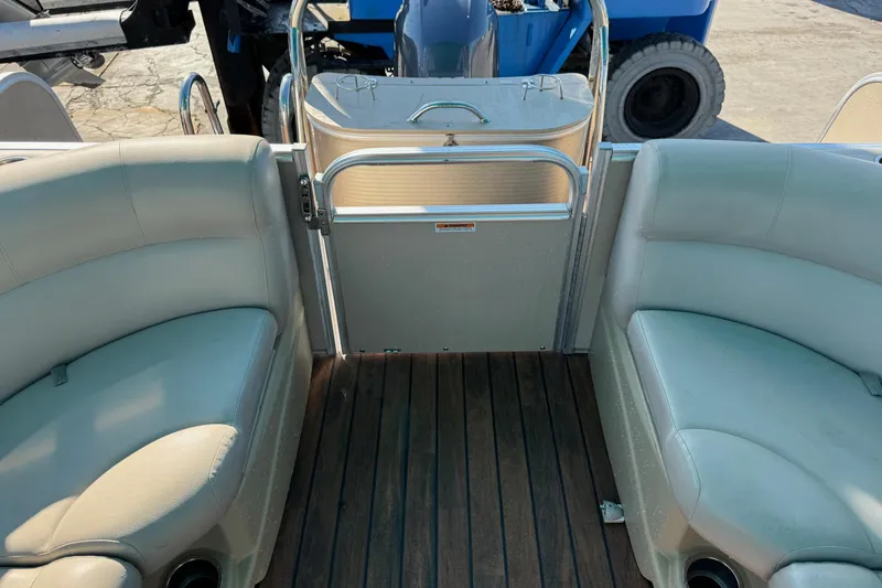 Slide: The Image of Interior view of a 2016 Avalon 2585 QL boat with beige seating and wooden flooring. - 8