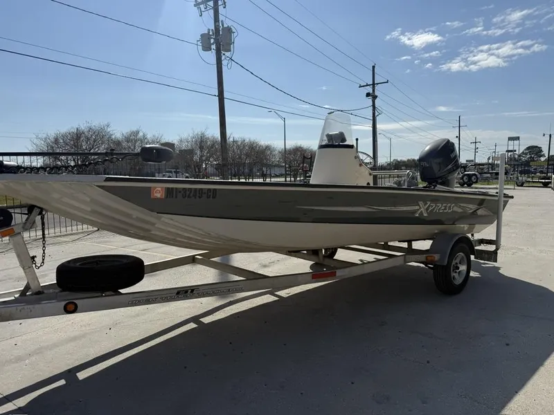 Slide: The Image of 2009 Xpress H20 BAY boat on trailer, parked outdoors under clear sky. - 4